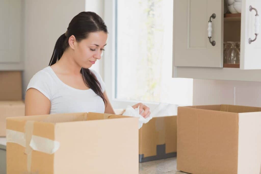 A woman is unpacking in the kitchen