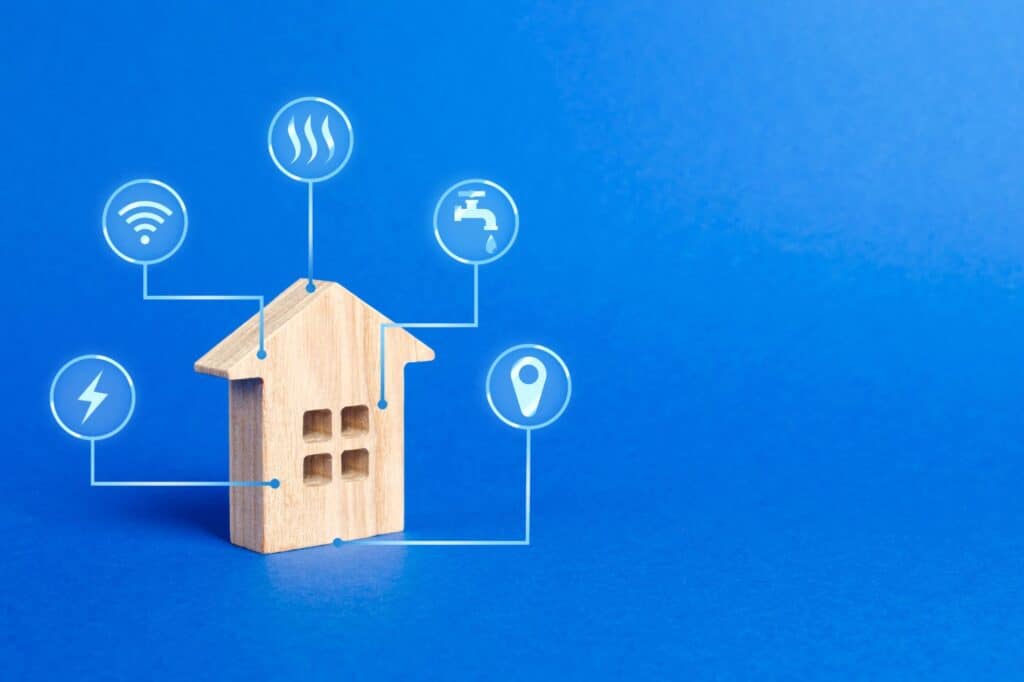 A house figurine with utility icons