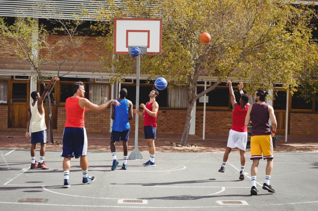 Young men playing on the basketball court