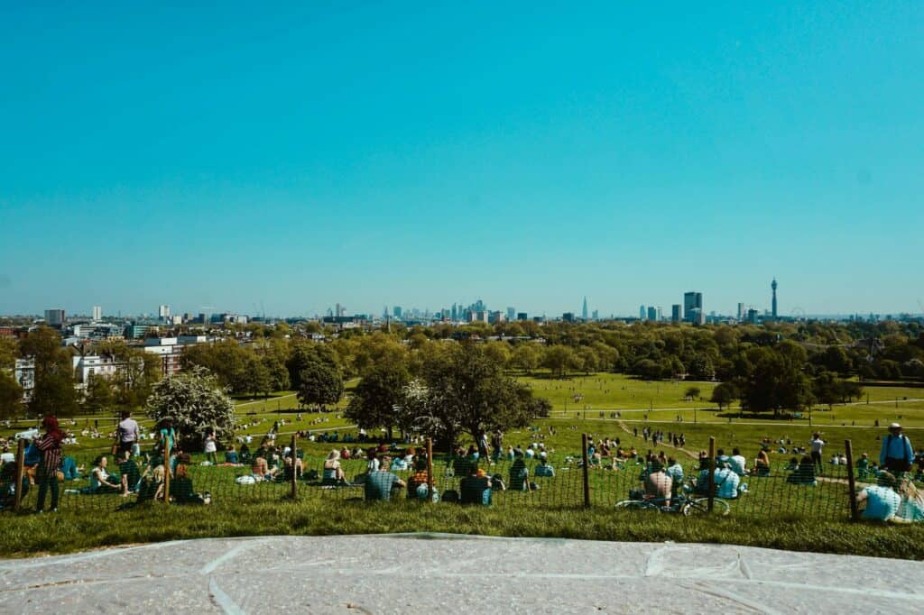 People relaxing on the lawn in the concept of parks and green spaces in Wood Green