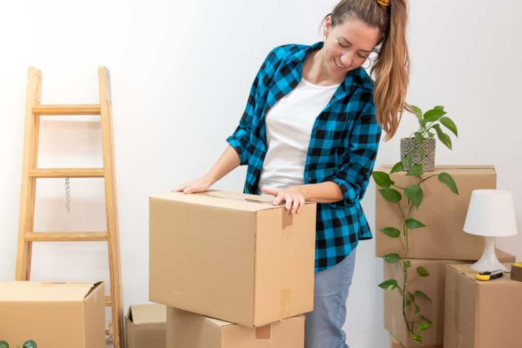 A student is stacking cardboard boxes for her move