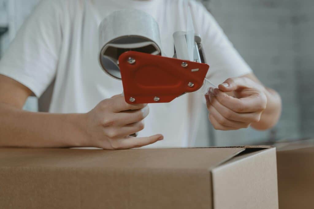 Cropped image of a woman's hands packing things