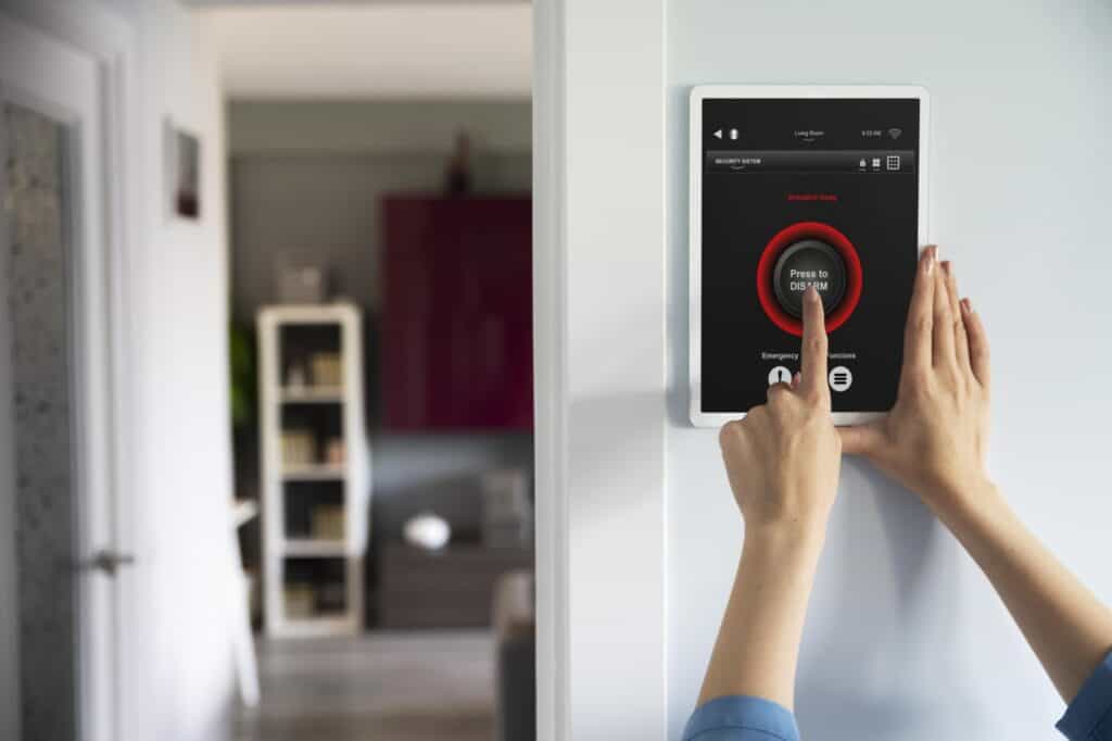 Cropped image of a woman's hand resetting the home security system